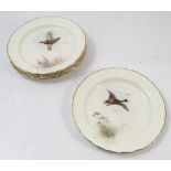 Six Royal Worcester plates, painted with different game birds in flight by Jas Stinton,