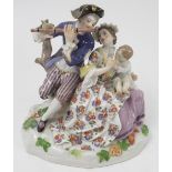 A 20th century Continental porcelain figure group, of a family group with the man playing a flute,