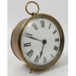 A circular brass cased clock, the white enamel dial with Roman numerals with circular case,