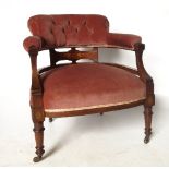 A late 19th century walnut nursing chair, of horseshoe form, with marquetry decoration to reverse,