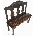 A late 19th century oak chair back settle, with three vase shaped splats to the back,