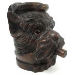 A Black Forest style carved novelty tobacco jar, carved as the face of a Scottie dog smoking,