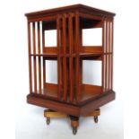 A satinwood revolving bookcase, with cross banded top, two tiers and slatted ends, width 19.