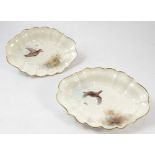 A pair of Royal Worcester oval dishes, painted with different game birds in flight by Jas Stinton,