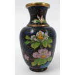 A cloisonne vase, decorated with flowers to a blue ground,