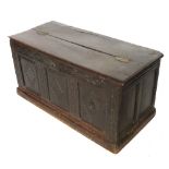 An Antique oak coffer, with altered part rising lid, with three part carved panels to the front,