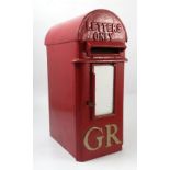 A red letter box, with arched top and gold GR,