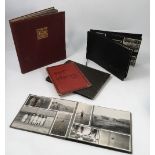 Four early 20th century black and white photograph albums,