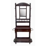 A mahogany hall stand, with mirror back, cloak hooks, drawer and stick stand to either side,