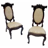 A pair of 19th century rosewood hall chairs, with oval upholstered back and seat,