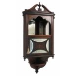 A 19th century rosewood hanging corner cabinet, with broken swan pediment over a mirror back shelf,