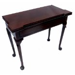 A Georgian design mahogany foldover tea table, fitted with a frieze drawer, raised on turned legs,