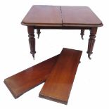 A 19th century mahogany extending dining table, raised on four turned and fluted legs,