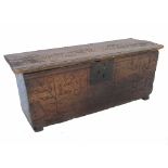 An early 18th century oak coffer, or sword box, with stylized floral carving to the front, width 34.