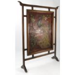 An oak framed Art Nouveau style fire screen,