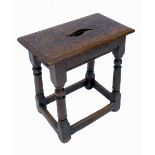 An Antique oak joint stool, of rectangular form, raised on turned legs united by stretcher,