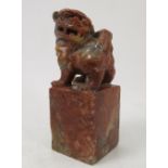 A carved soapstone figure of a dog of fo, raised on a square pedestal base, height 6.