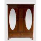 An Edwardian mahogany double mirror door wardrobe, fitted two drawers to the base,