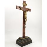 A 19th century table top crucifix, the gilt metal model of Christ nailed to a zebrawood cross,