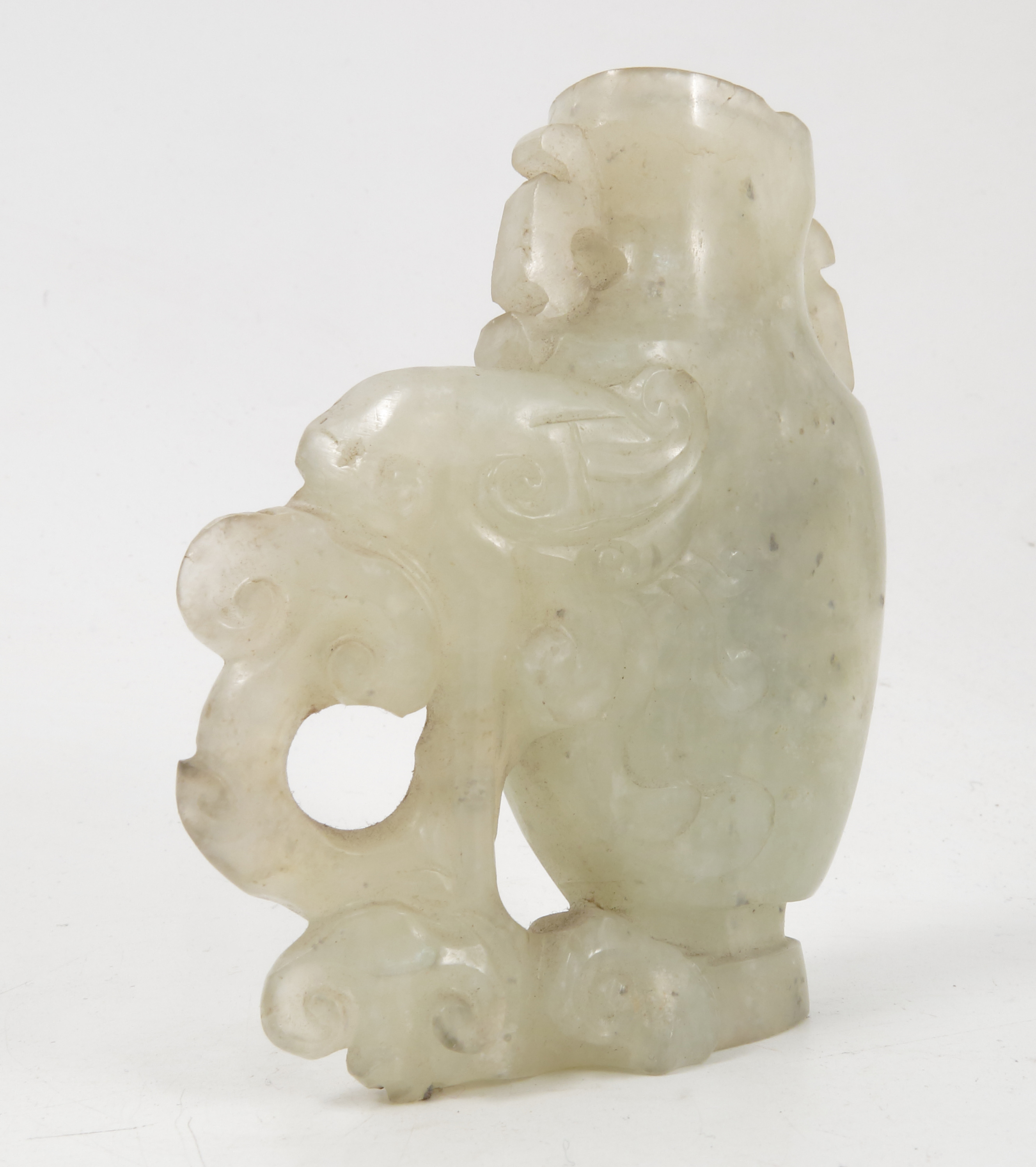 A carved hardstone vase, possibly white jade, of a stylized elephant and foliage, height 3. - Image 4 of 4