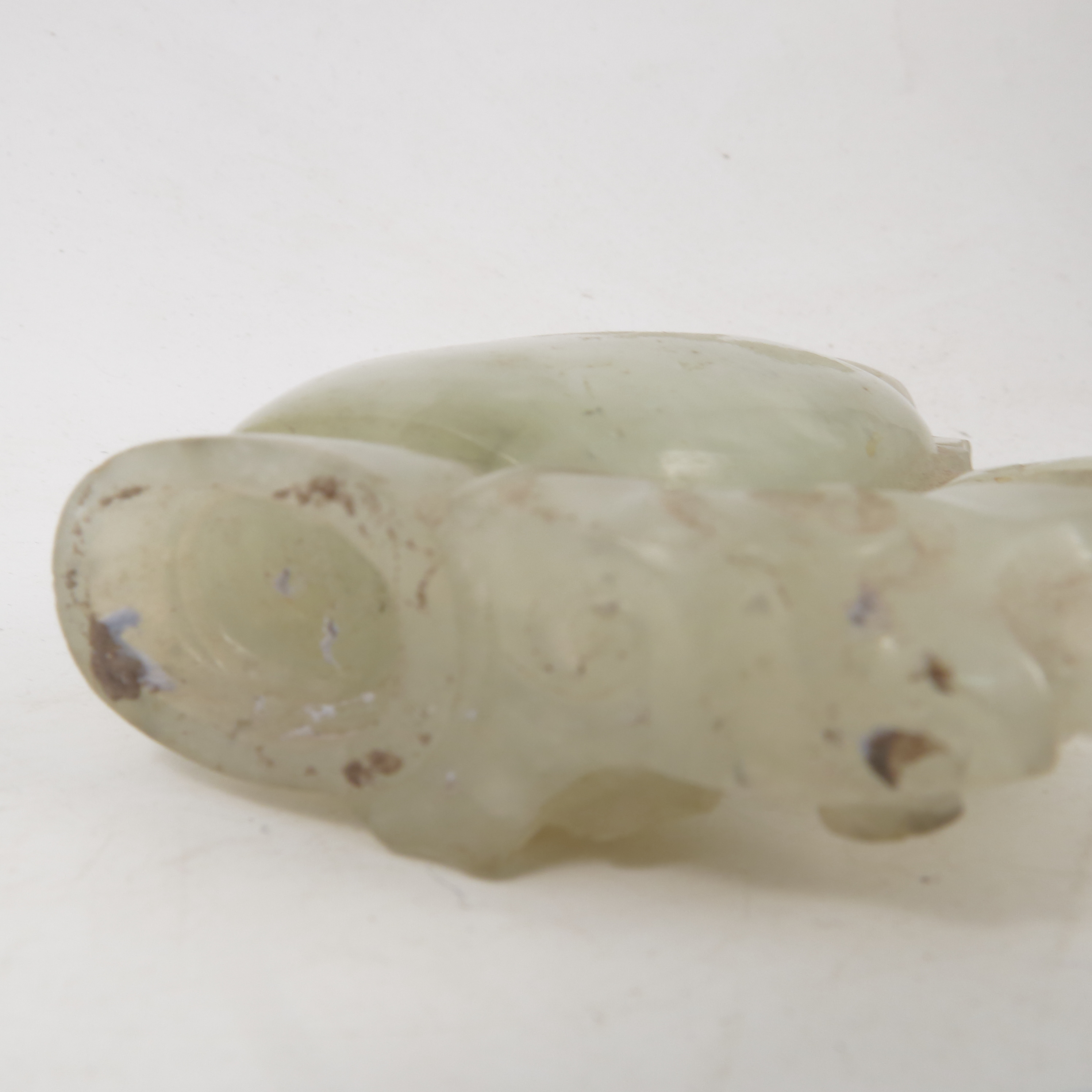 A carved hardstone vase, possibly white jade, of a stylized elephant and foliage, height 3. - Image 2 of 4