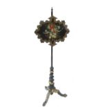 A 19th century ebonised and papier mache pole screen,