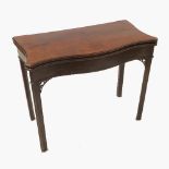 A Georgian mahogany serpentine fronted fold over games table, raised on moulded chamfered legs,