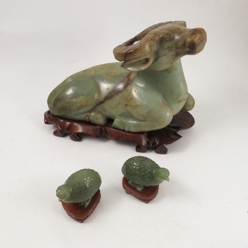 A green stone carved study, of a recumbent buffalo, length 12ins,