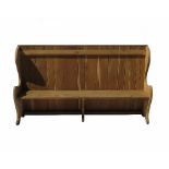 An oak settle, with plank back, solid seat, and shaped ends,