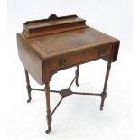 A late Victorian walnut writing table, with rising stationery compartment, drawer and drop flaps,