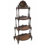 A Victorian walnut four tier graduated what not, with boxwood line inlay and mirror back,