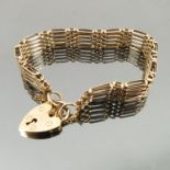 A 9 carat gold bracelet, of pine bar gate links to a padlock clasp, weight 17.