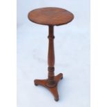 A 19th century satinwood wine table, raised on a turned column on a flared tripod base, width 11.