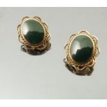 A pair of green hardstone ear clips,