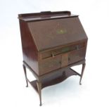 An Edwardian mahogany bureau, with fall flap opening to reveal pigeonholes to interior,