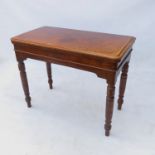 A 19th century burr walnut fold-over card table, with a quarter veneer top raised on turned legs,