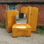 An Art Deco style bedroom suite, comprising mirror-backed dressing table with drawers and cupboards,