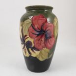 A Moorcroft Pottery vase, decorated in the Hibiscus pattern, height 8.