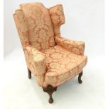 A Georgian style wing back armchair,