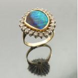 A boulder opal and diamond cluster 18 carat gold ring,