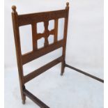 An Arts & Crafts Glasgow school Celtic style golden oak single bed, by Wylie and Lochhead Ltd,