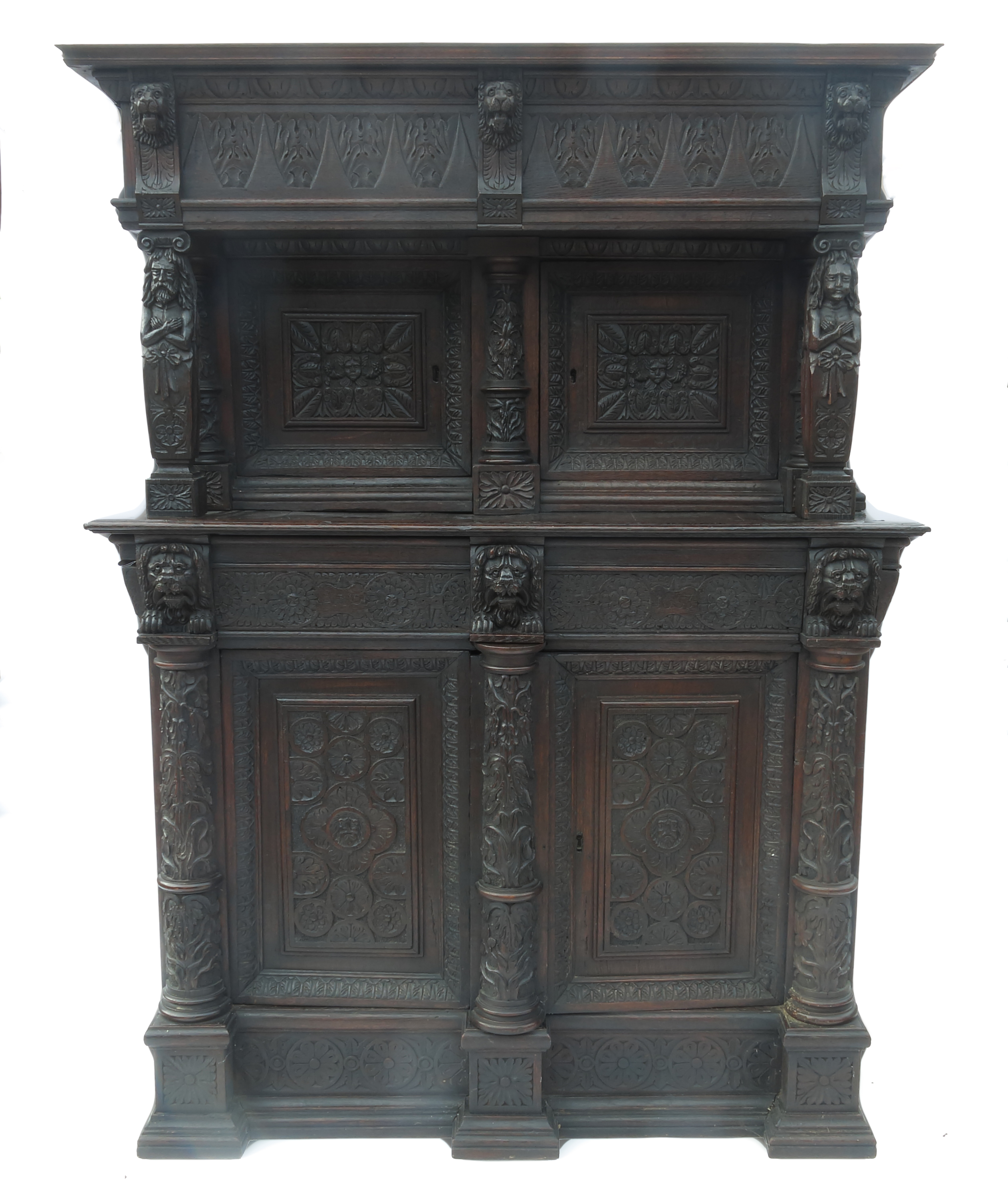 An antique oak cupboard, with canopy top over two doors flanked by columns,