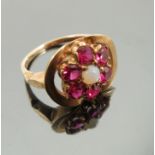 Eva Braun, a gold cluster ring, set with an opal surrounded by six rubies,