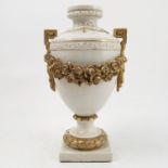 A Continental porcelain urn, the white body decorated with gilt greek key and drape handles,
