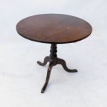 A 19th century oak circular occasional table, raised on tripod base,