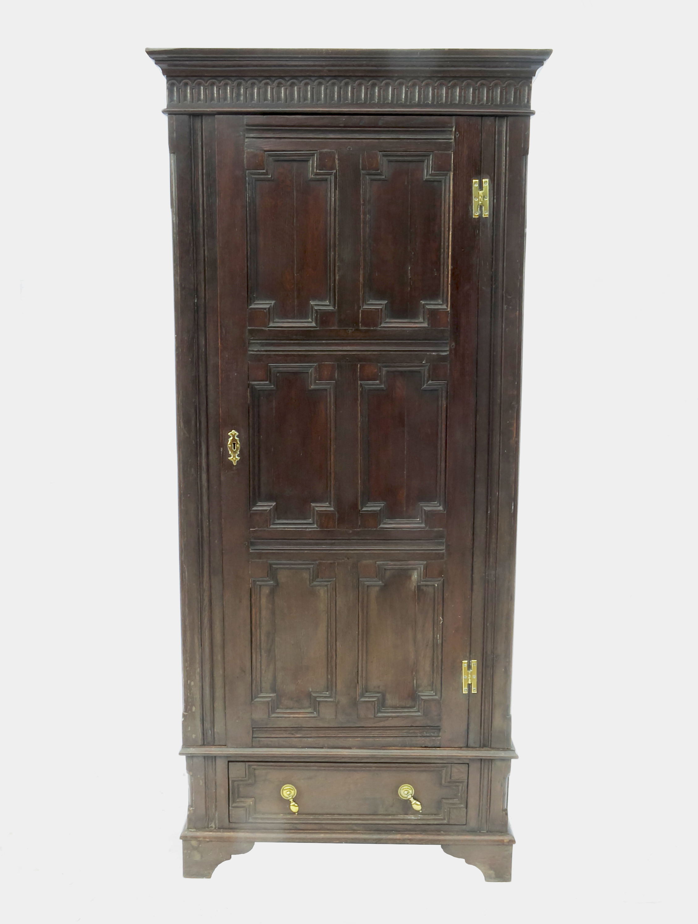 An antique oak cupboard, with a moulded panel door fitted with a drawer,