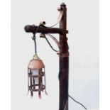 An Arts & Crafts style oak standard lamp with adjustable column,