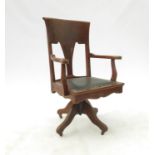 An early 20th century mahogany frame swivel office chair