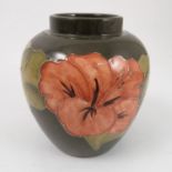 A Moorcroft Pottery vase, decorated in the Hibiscus pattern, lacking cover,