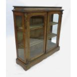 A Victorian burr walnut double door pier cabinet, having a crossbanded top, cushion frieze,